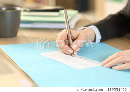 Entrepreneur hands filling bank check at homeoffice Entrepreneur hands filling bank check at homeoffice 119551412