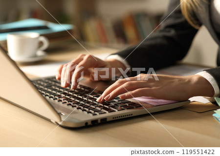 Entrepreneur hands typing on laptop at night 119551422