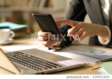 Entrepreneur hands using phone at night at home 119551424