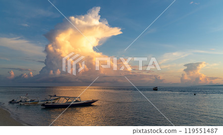 A small boat is gently floating atop a calm body of water A small boat is gently floating atop a calm body of water 119551487