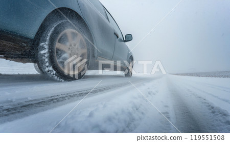 Driving a car on a snowy road with poor visibility. Low angle 119551508