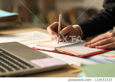 Entrepreneur hands writing on agenda at night at home 119551515