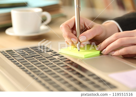 Entrepreneur hands writing reminder on post note 119551516