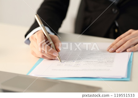 Executive hands filling form at the office 119551533