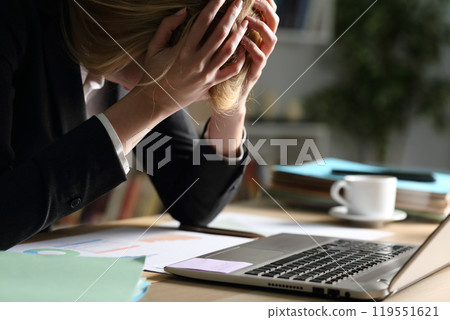 Sad entrepreneur complaining over bad results at night 119551621