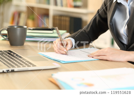 Self employed hands filling checkbox form at homeoffice Self employed hands filling checkbox form at homeoffice 119551628