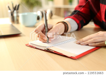 Student girl hands writing reminder on agenda Student girl hands writing reminder on agenda 119551663