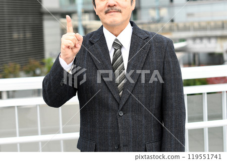 Middle-aged businessman in a suit outdoors Middle-aged businessman in a suit outdoors 119551741