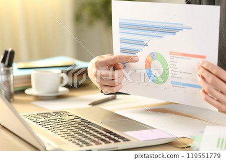 Teleworker showing chart on video call using laptop Teleworker showing chart on video call using laptop 119551779