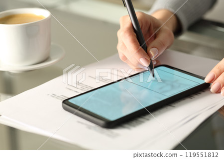 Woman hand signing online document with smart phone Woman hand signing online document with smart phone 119551812
