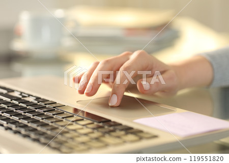Woman hand with laptop using touchpad on a desk 119551820