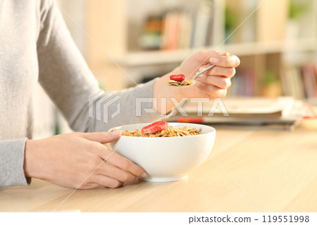 Woman hands dieting eating cereal bowl at home 119551998
