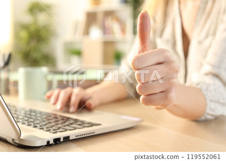 Woman hands using laptop with thumbs up 119552061