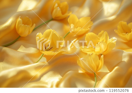 Yellow tulips are scattered across a shimmering yellow silk background, creating a vibrant and luxurious display, perfect for celebrating March 8th or Valentine's Day 119552076