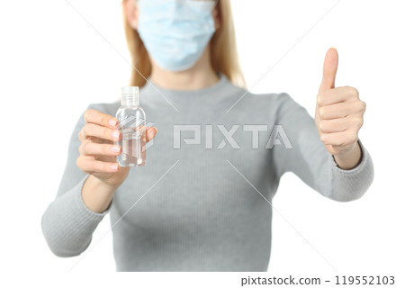 Woman with mask and sanitizer doing thumb up isolated on white Woman with mask and sanitizer doing thumb up isolated on white 119552103