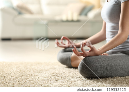 Close up of a woman doing yoga at home Close up of a woman doing yoga at home 119552325