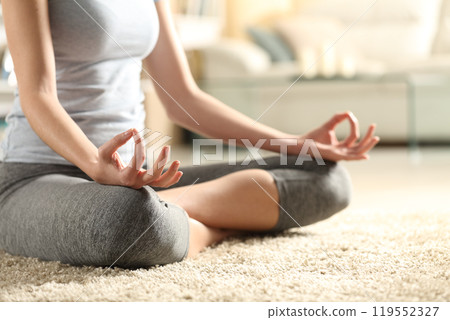 Close up of a woman hands doing yoga exercise at home 119552327