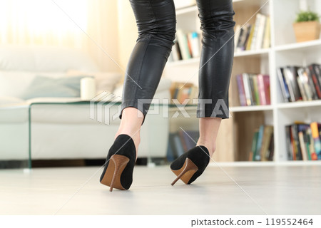 Woman with high heels walking and sprain ankle 119552464