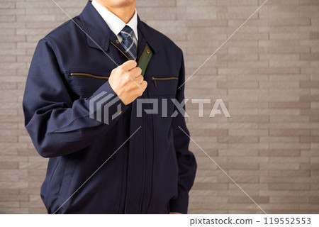 Middle-aged male businessman wearing work clothes making a fist pump Middle-aged male businessman wearing work clothes making a fist pump 119552553