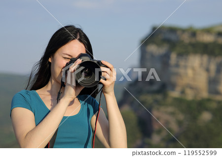 Asian tourist taking photos with dslr camera Asian tourist taking photos with dslr camera 119552599