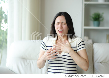 Asian woman chocking suffering asthma attack at home Asian woman chocking suffering asthma attack at home 119552609