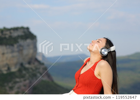 Asian woman relaxing and breathing listening audio in nature Asian woman relaxing and breathing listening audio in nature 119552647