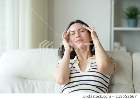 Asian woman suffering migraine at home 119552667