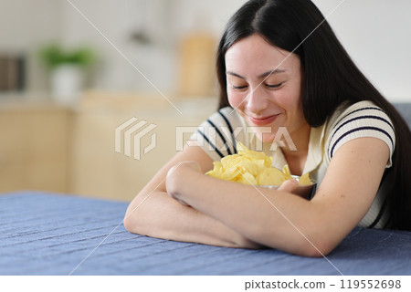 Gluttonous asian woman ready to eat potato chips Gluttonous asian woman ready to eat potato chips 119552698