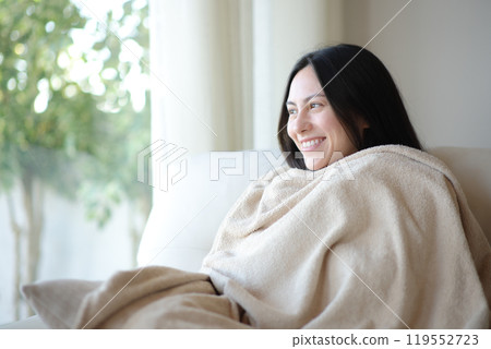 Happy asian woman keeping warm with blanket at home Happy asian woman keeping warm with blanket at home 119552723