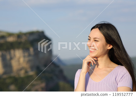 Pensive asian woman looking at side in nature 119552777