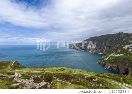 Coastal cliffs of Slieve League stretching along the Atlantic with rolling green hills Coastal cliffs of Slieve League stretching along the Atlantic with rolling green hills 119552884