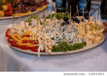 Vibrant Cheese Platter with Colorful Accompaniments and Garnishes 119553655