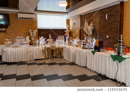 Elegant Banquet Setup with Desserts and Decorations 119553670
