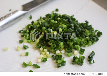 Chopped green onions on a cutting board Chopped green onions on a cutting board 119554803