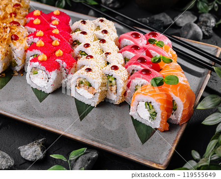 Assorted sushi platter on dark stone background Assorted sushi platter on dark stone background 119555649