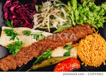 Traditional turkish adana kebab serving with vegetables and bulgur rice pilaf 119555681