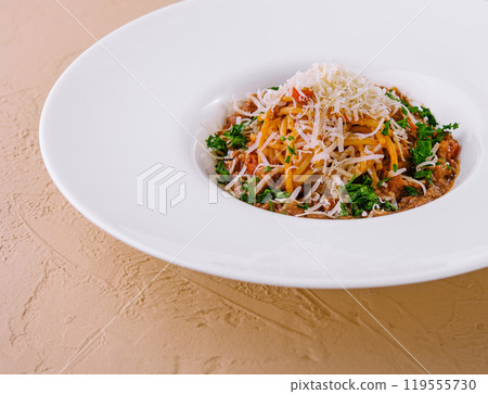Gourmet spaghetti bolognese with parmesan on white plate Gourmet spaghetti bolognese with parmesan on white plate 119555730