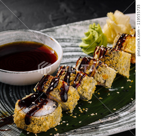 Delectable sushi roll platter with soy sauce 119555735