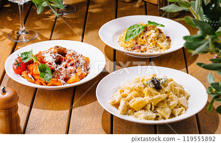 Variety of italian pasta on rustic wooden table 119555892