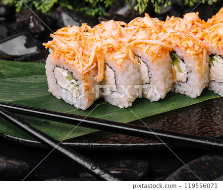 Fresh sushi roll platter with spicy carrot topping 119556071