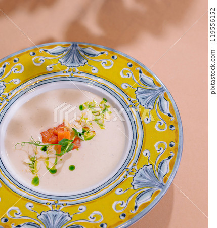 Elegant soup presentation in ornate plate Elegant soup presentation in ornate plate 119556152