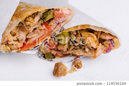 Delicious chicken shawarma lying on white background 119556184
