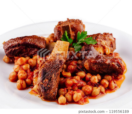 Delicious braised lamb shanks with chickpeas served on white plate Delicious braised lamb shanks with chickpeas served on white plate 119556189