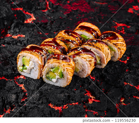 Delicious spicy sushi roll on charcoal background Delicious spicy sushi roll on charcoal background 119556230