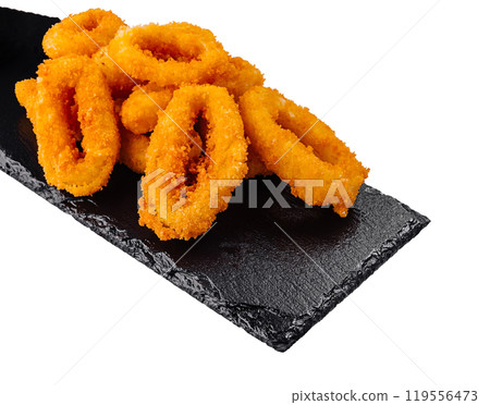 Breaded calamari rings served on black slate with dipping sauce Breaded calamari rings served on black slate with dipping sauce 119556473