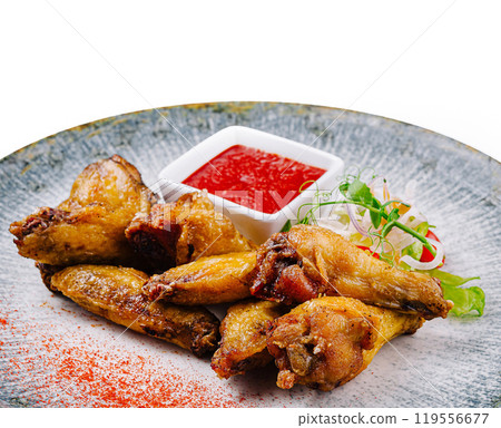 Delicious fried chicken wings being served with salad and tomato sauce Delicious fried chicken wings being served with salad and tomato sauce 119556677