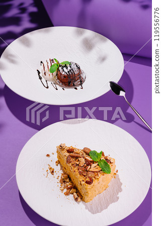 Two delicious desserts are served on a modern purple background with contrasting shadows 119556776