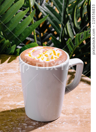 Steaming mug of hot chocolate with whipped cream and caramel drizzle enjoying tropical atmosphere Steaming mug of hot chocolate with whipped cream and caramel drizzle enjoying tropical atmosphere 119556833