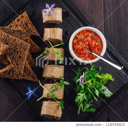 Restaurant is serving delicious chicken liver pate on black stone plate Restaurant is serving delicious chicken liver pate on black stone plate 119556925
