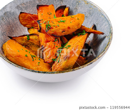 Baked sweet potato fries being served in bowl Baked sweet potato fries being served in bowl 119556944
